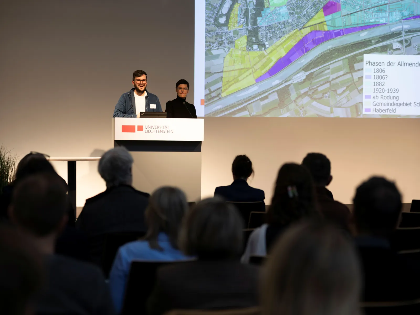 Eine Person präsentiert an einem Vortragspult