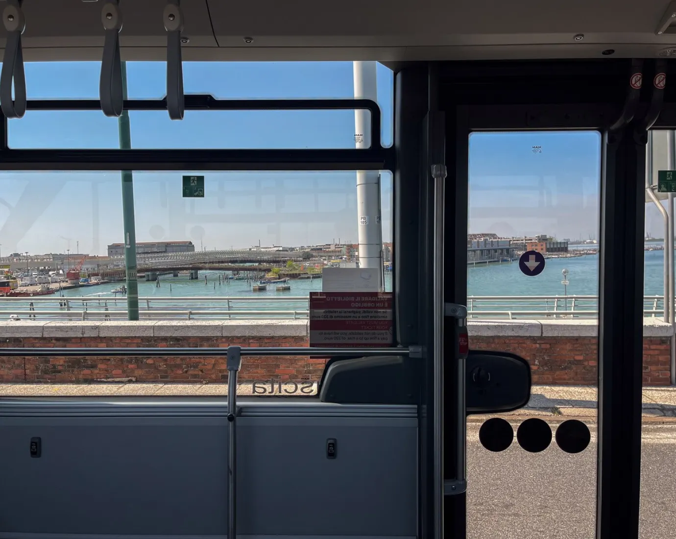 View from a bus onto water and harbor.